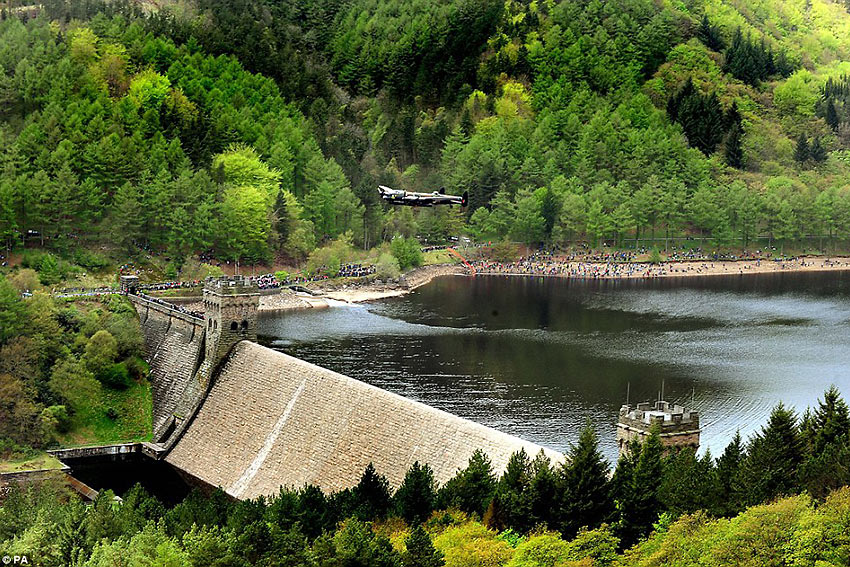 Lancaster Bomber flying low over the Derwent Dam in a recreation of the Moehne Dam Raid of 1943