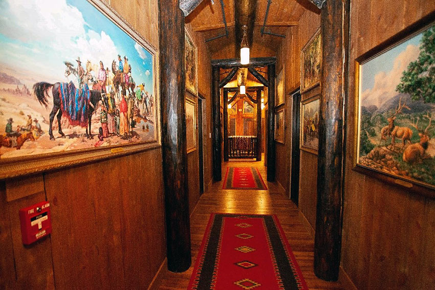 native American paintings at the walls of a hallway at Cloud Camp