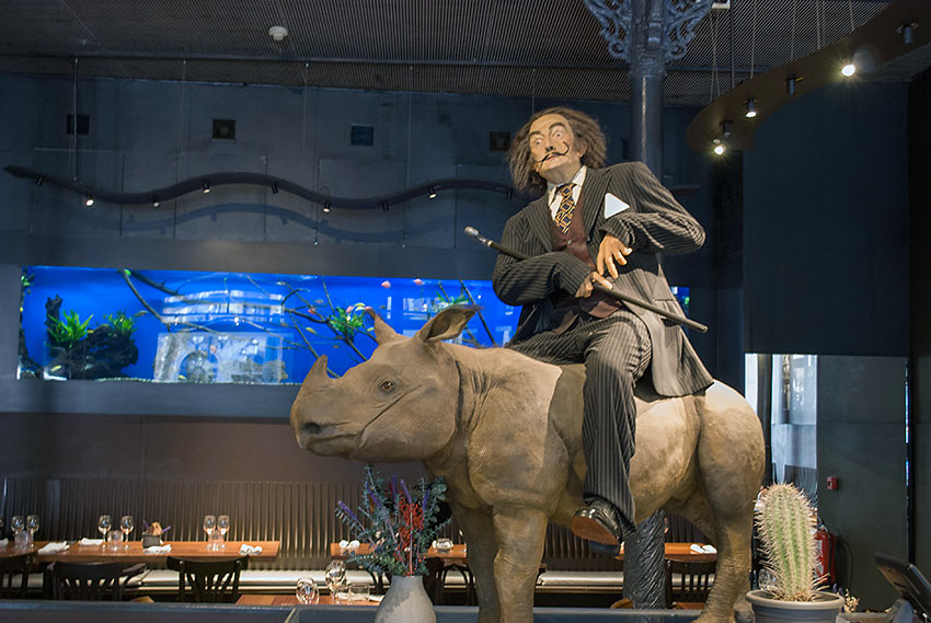 a large print of Dali riding a baby rhinoceros