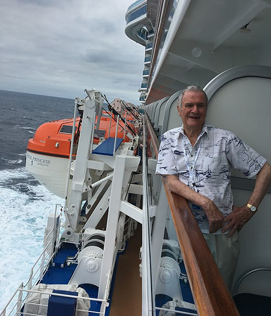 author John Clayton at a balcony on the Royal Princess