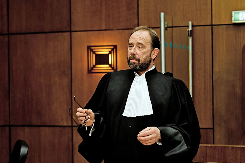 Olivier Gourmet as the attorney for the defense in 'Conviction'