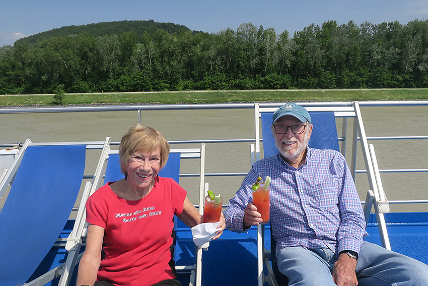 writer and her husband relaxing on deck with Bloody Mary