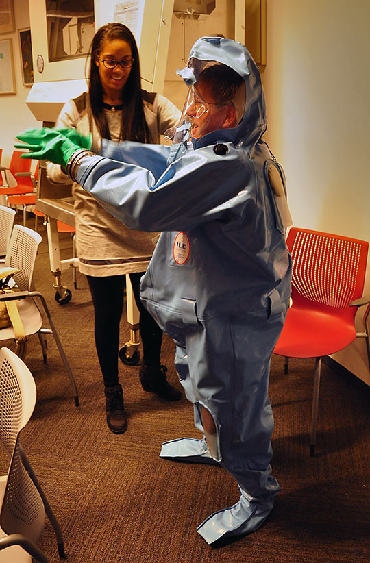 putting on a biosafety suit at the David J. Sencer CDC Museum