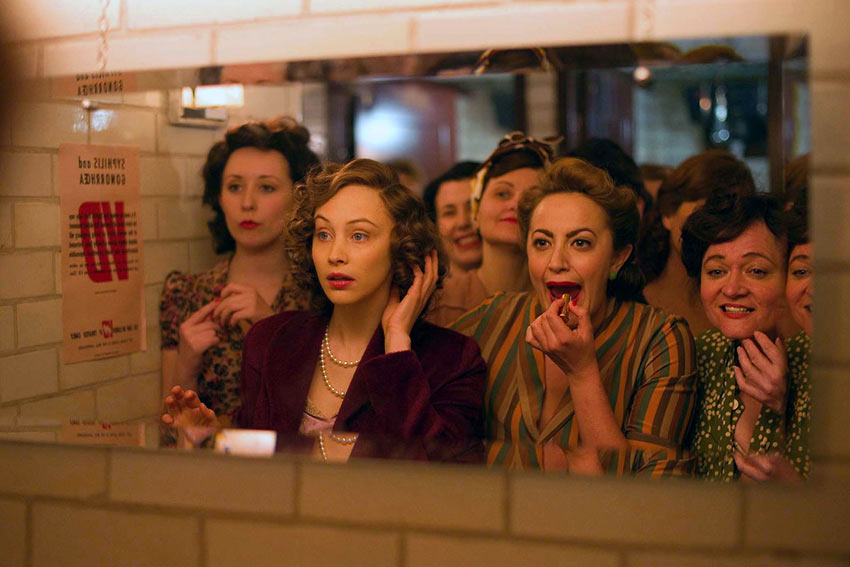 Elizabeth (Sarah Gadon) finds herself in the ladies room