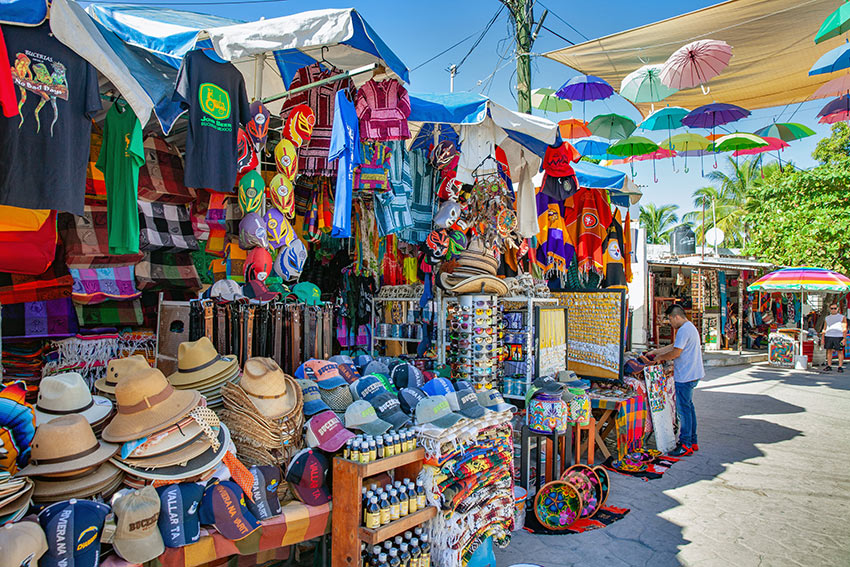 hats, fabrics, and leather belts for sale at Bucerias