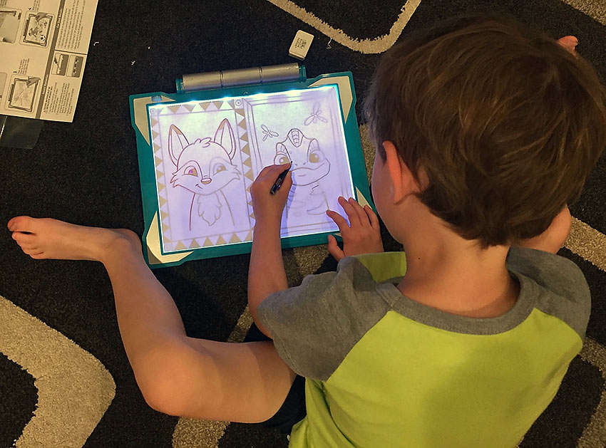 kid with Crayola Light Up Tracing Pad