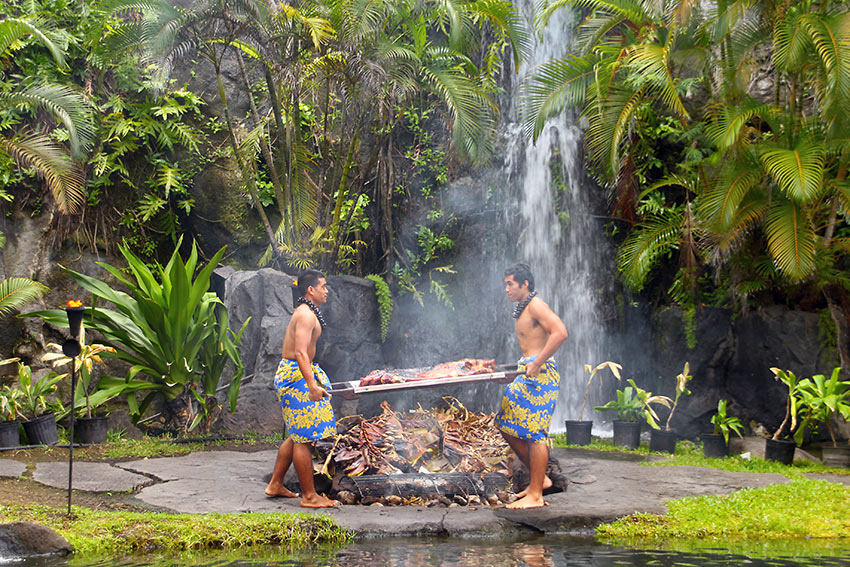 cooking Kalua Pig in an imU underground oven