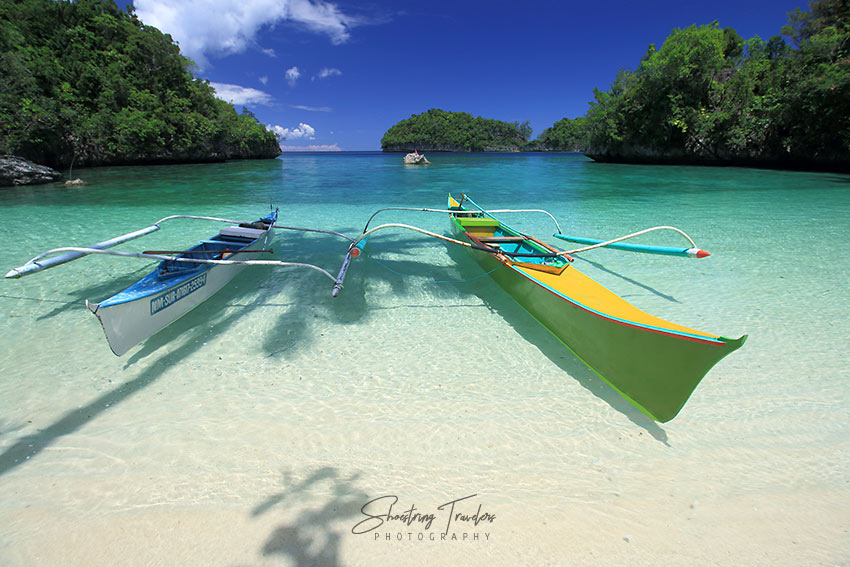 outrigger boats along the beach at Babas Cove