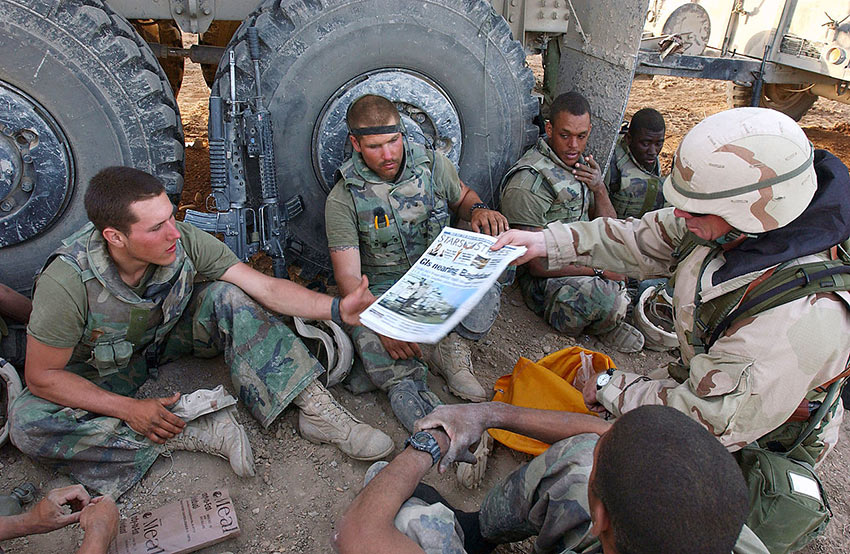 copies of the Stars and Stripes being delivered to Marines of Task Force Tarawa