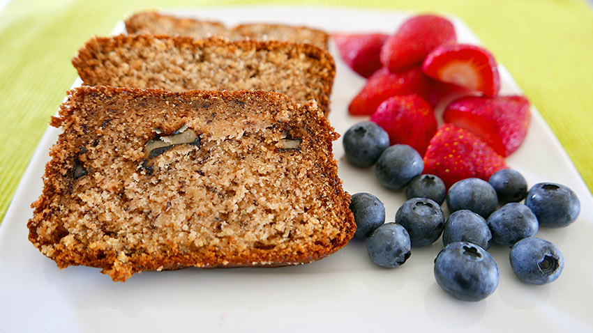 banana bread with walnuts and a side of berries