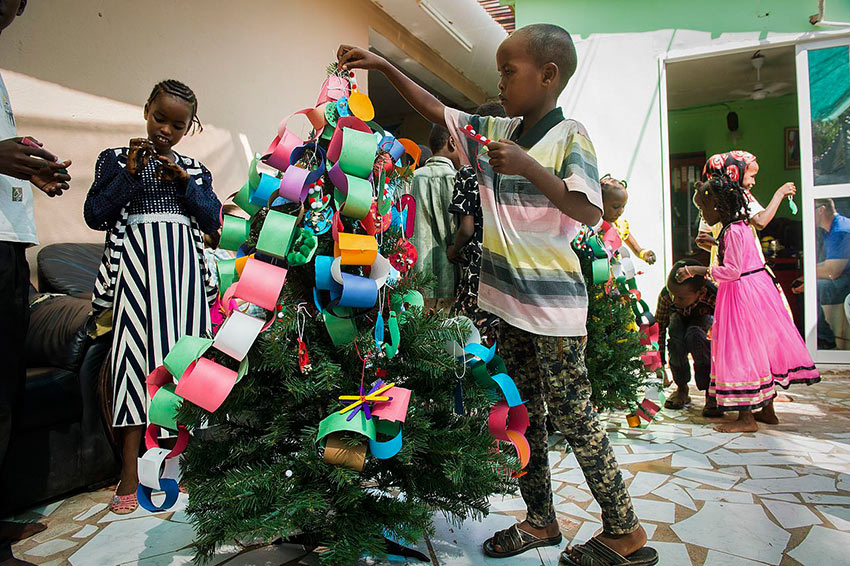 Children in an Ethiopian orphanage decorating a Christmas tree