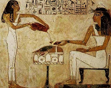 Egyptian woman pouring beer