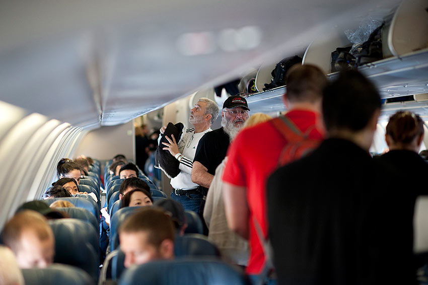 passengers board a packed Delta Air Lines aircraft