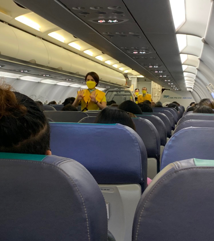 Friendly Cebu Pacific Air stewardesses with their simple yellow T-shirt uniforms.